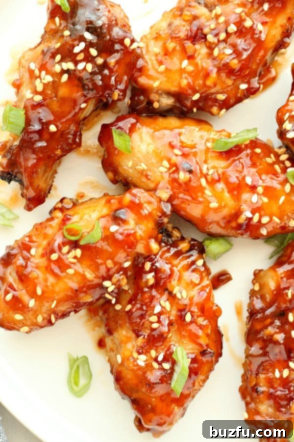 Asian chicken wings on a white plate.