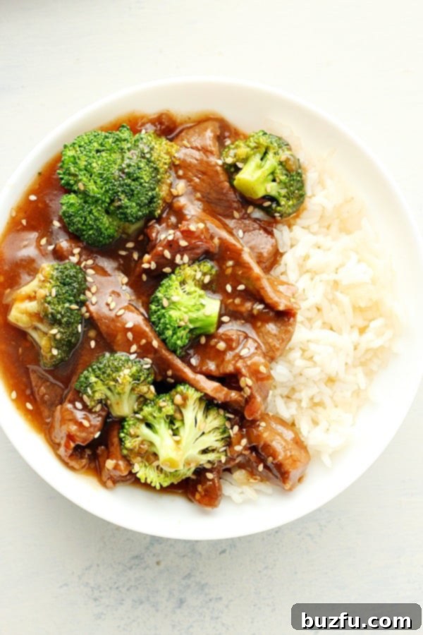 Close-up shot of Instant Pot Beef and Broccoli served in a bowl with rice.