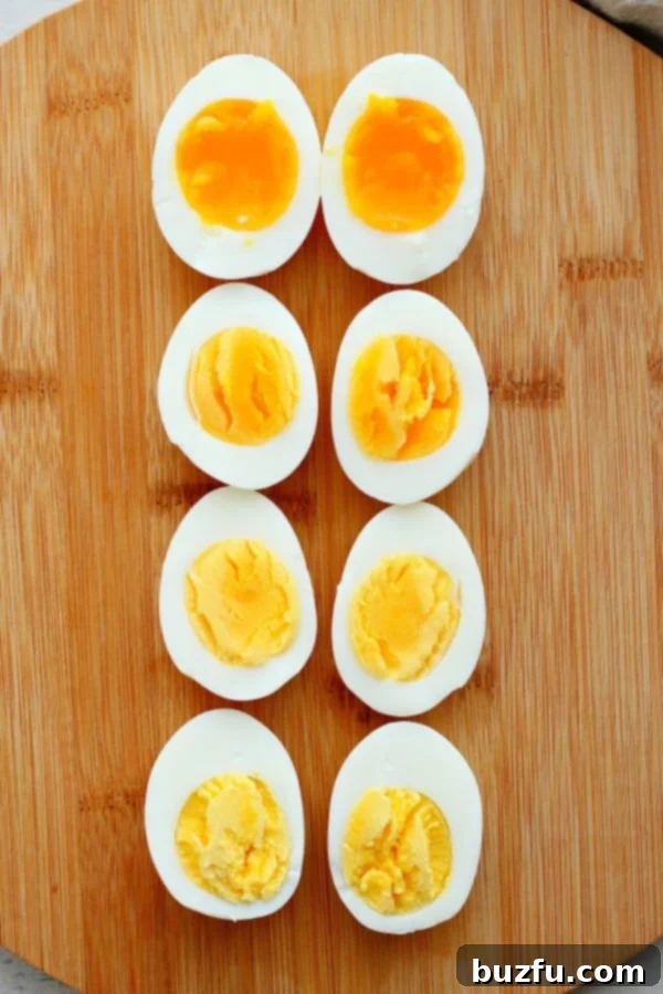 Best Boiled Eggs recipe Sliced cooked eggs on a cutting board, showcasing different levels of doneness.