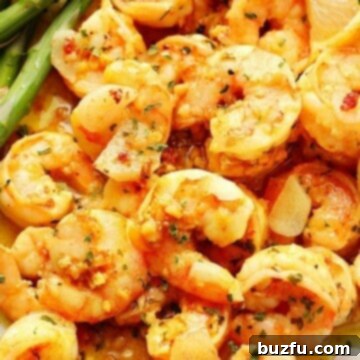 Garlic butter shrimp on a plate with asparagus.