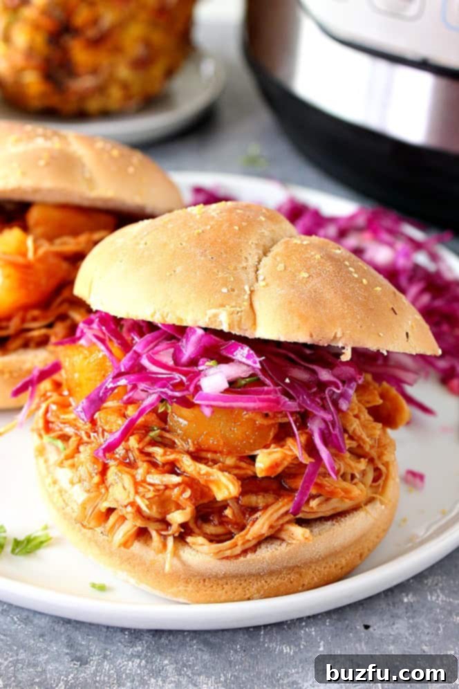 Instant Pot Hawaiian BBQ Chicken sandwiches, served on white plates with a refreshing side of coleslaw.