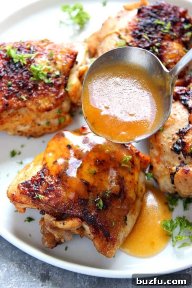 Perfectly cooked Instant Pot Chicken Thighs, generously drizzled with rich, homemade gravy.