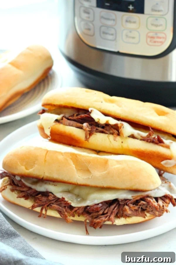 A mouth-watering French Dip sandwich on a plate, with a side of savory au jus for dipping.