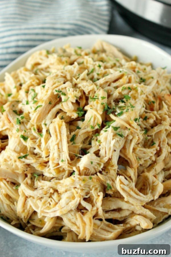 Instant Pot Salsa Verde Chicken, beautifully shredded and vibrant, served in a rustic bowl.