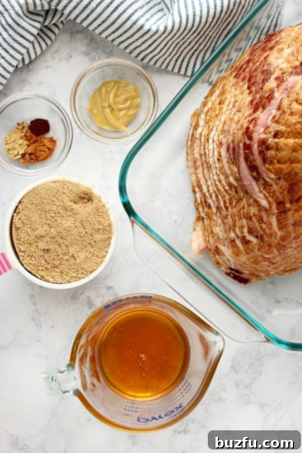 Ingredients for baked ham on a marble board, including honey, brown sugar, and spices.