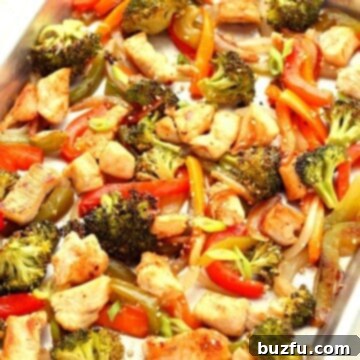 Chicken and colorful vegetables roasted on a sheet pan, a delicious sheet pan stir fry.