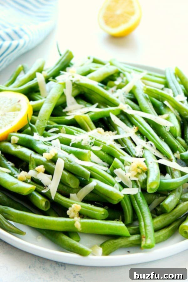 Snaps 2 Vibrant green beans steamed to perfection in an Instant Pot, garnished with lemon and Parmesan.