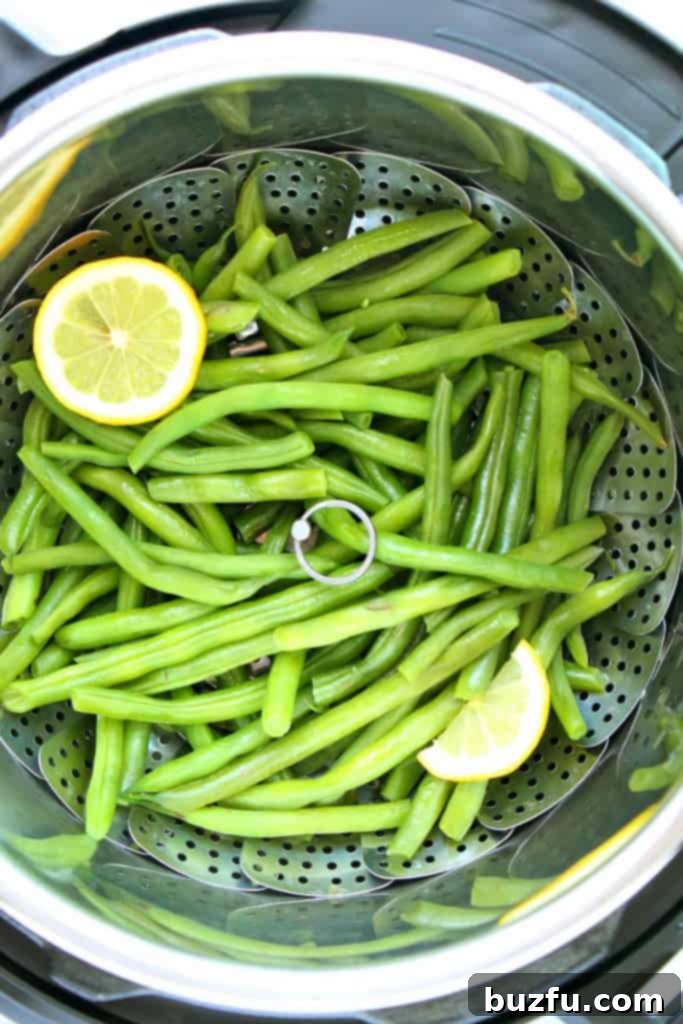 Snaps 3 Close-up of vibrant green beans in a pressure cooker before cooking, ready for steaming.