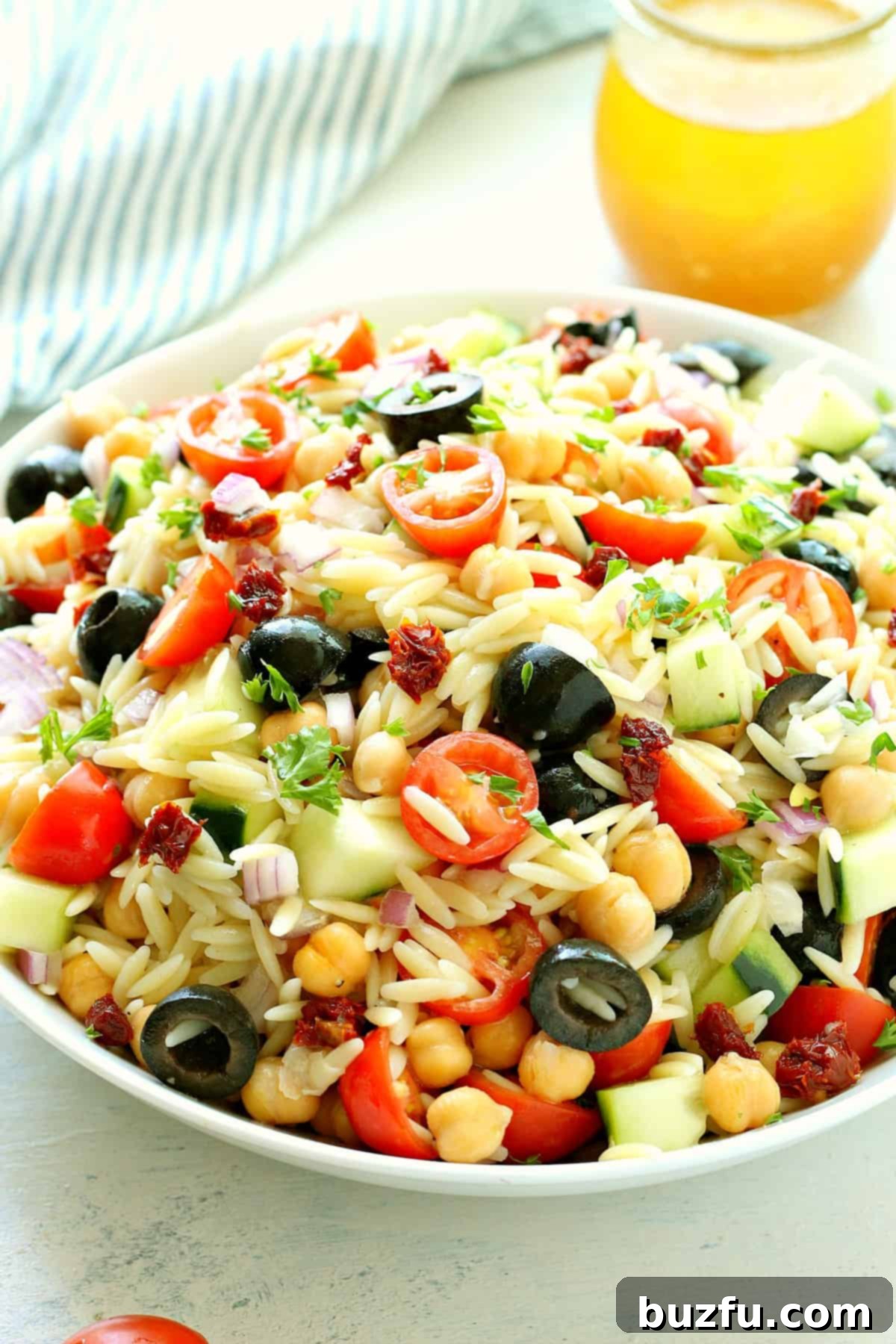 Pasta salad with vibrant veggies in a large bowl, ready to be served.