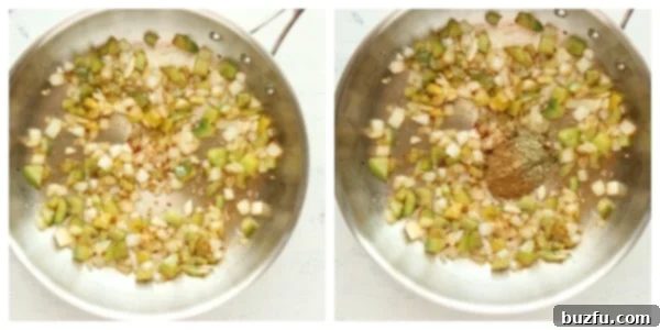 Chopped onion and bell pepper being sautéed in a skillet with olive oil.