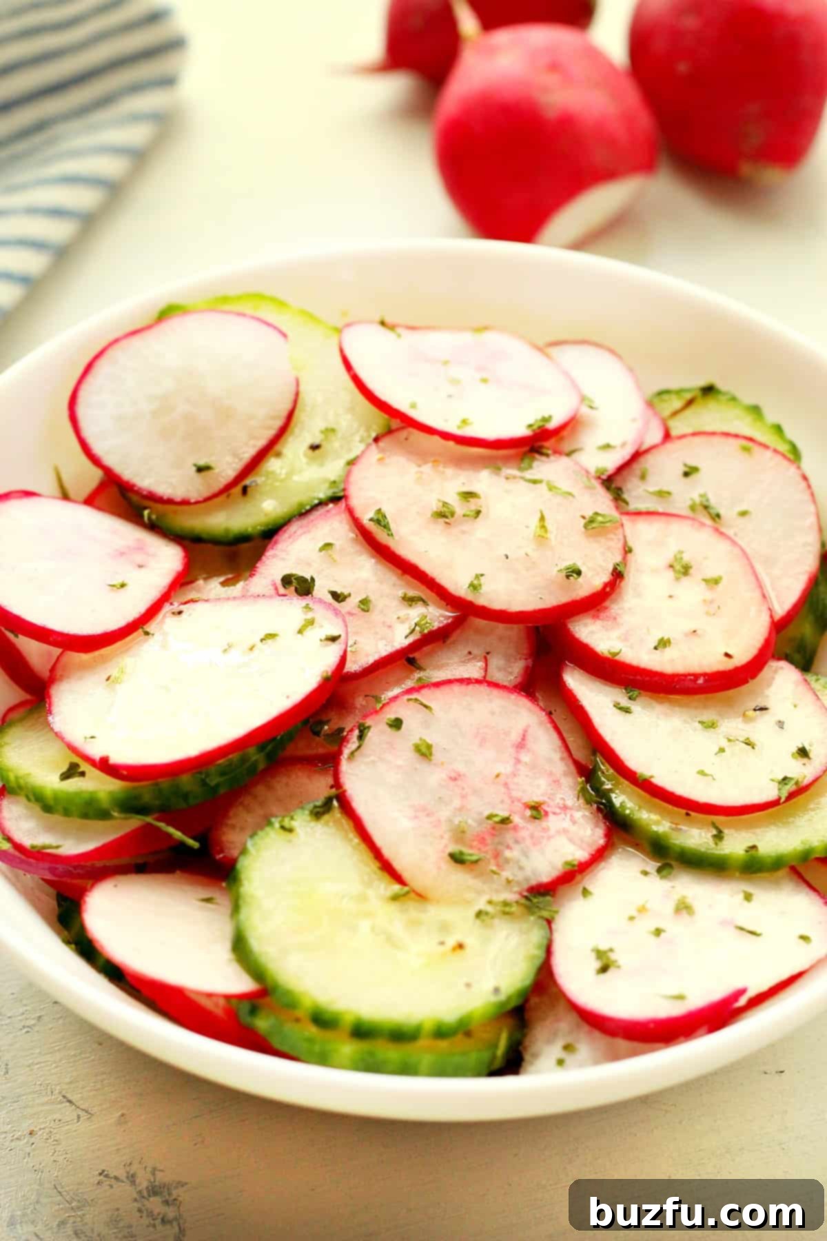 Vibrant Quick Radish Salad with crisp radishes, cucumber, and red onion, freshly tossed in a light vinaigrette, glistening and ready to serve.