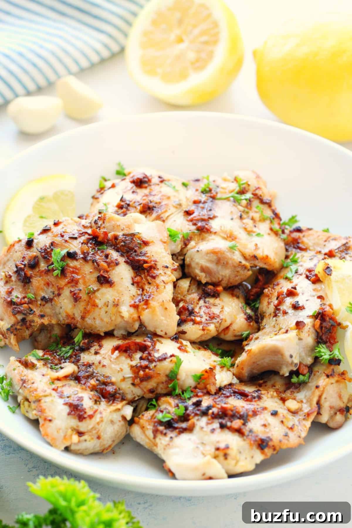 Chicken thighs in a white bowl.