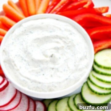 Creamy Veggie Dip in a rustic white bowl, surrounded by an assortment of colorful fresh vegetables.