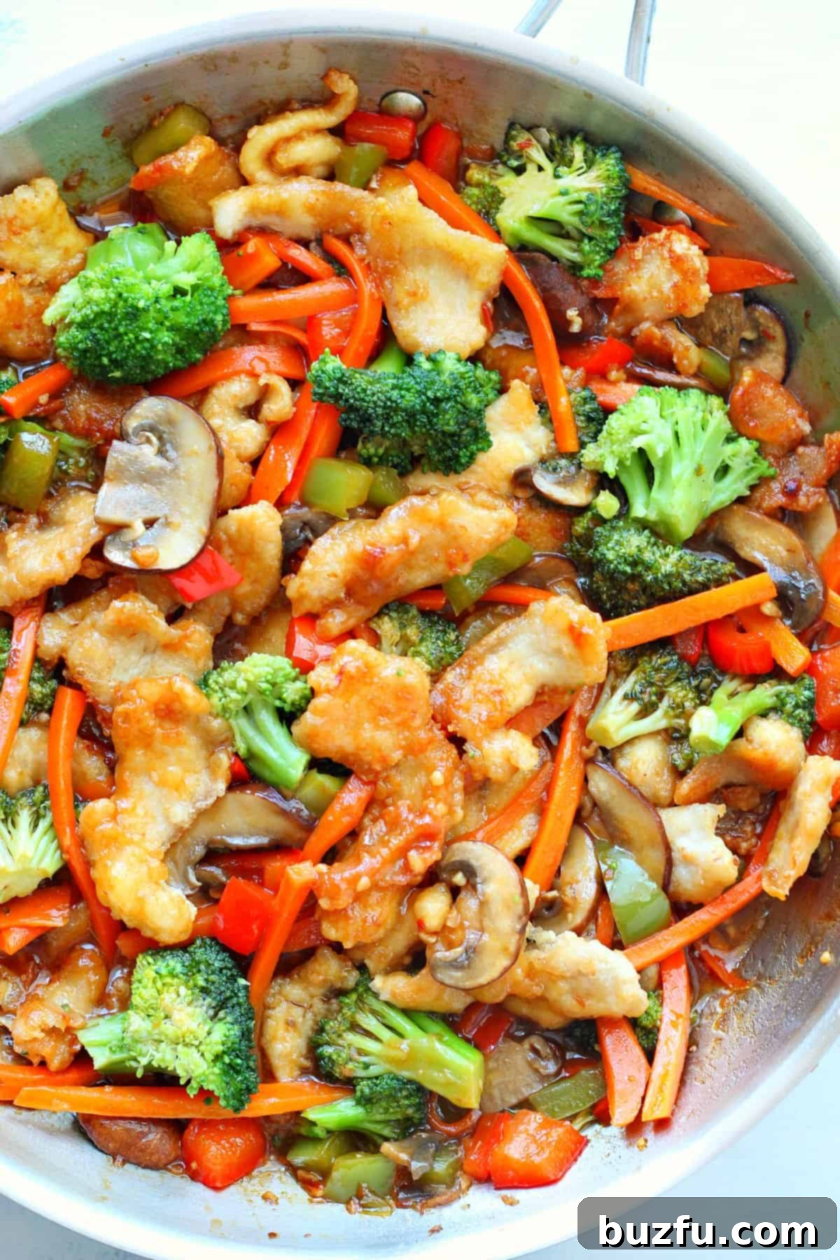 Chicken and veggies in a skillet, ready to be served as Hunan Chicken.
