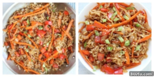 Close-up of pan-fried noodles and stir-fried vegetables being mixed with a savory sauce in a skillet.