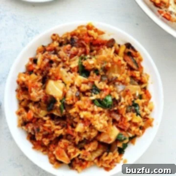 Sizzling Kimchi Fried Rice 3 Rice with kimchi in a white bowl.