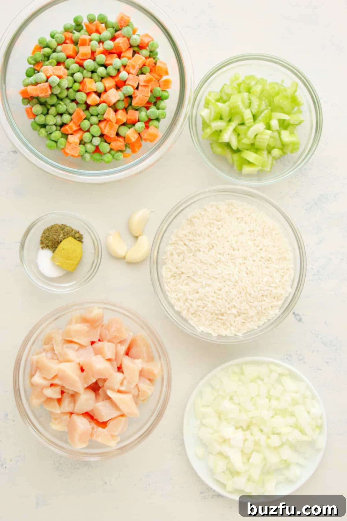 Ingredients for Instant Pot Chicken and Rice laid out on a white board.