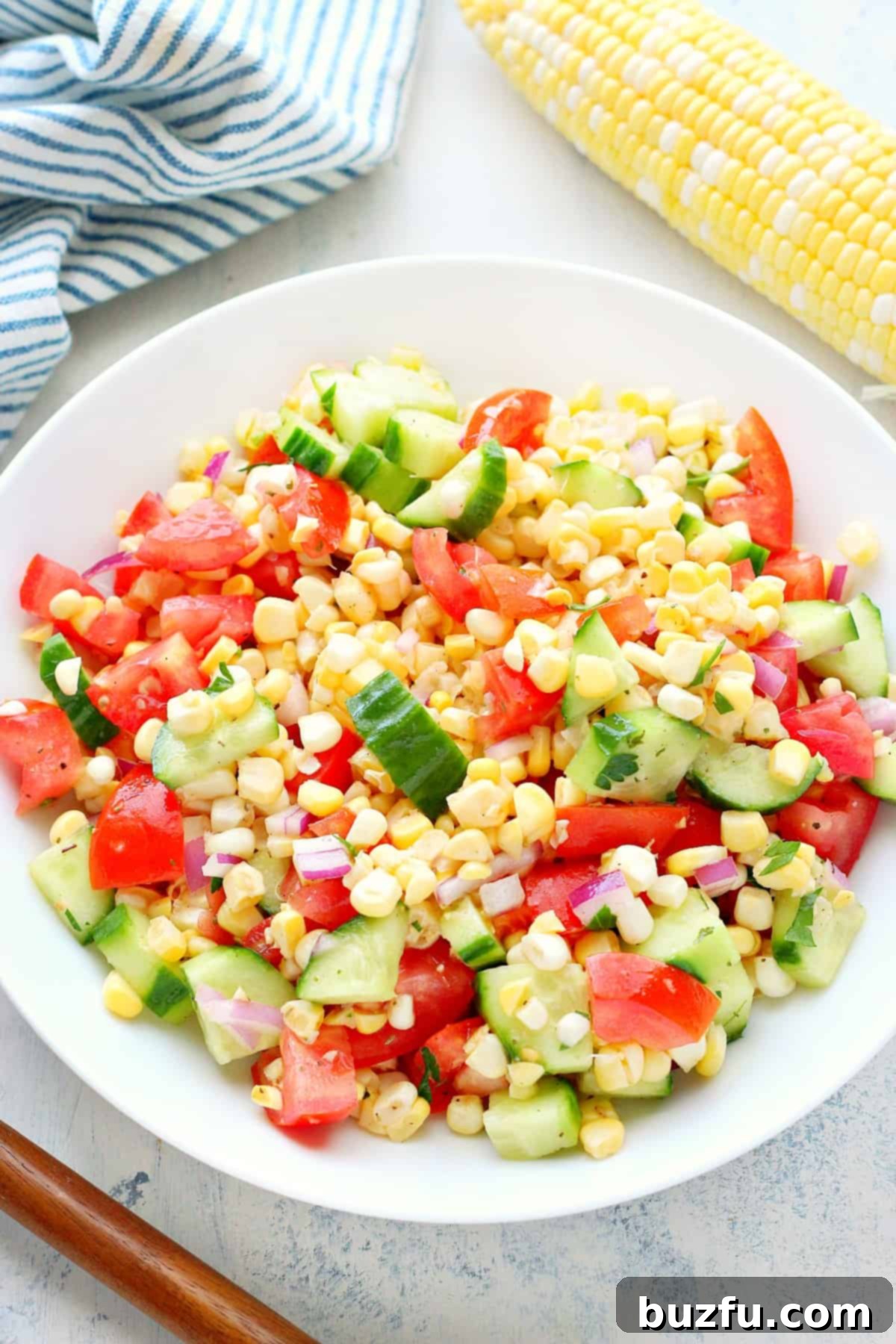 Corn salad in a white serving bowl.