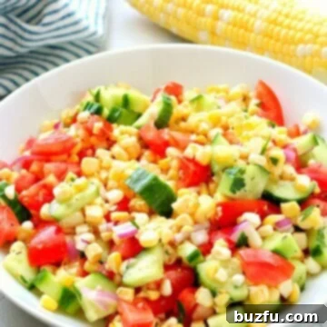 Corn, tomatoes and cucumber in a bowl.