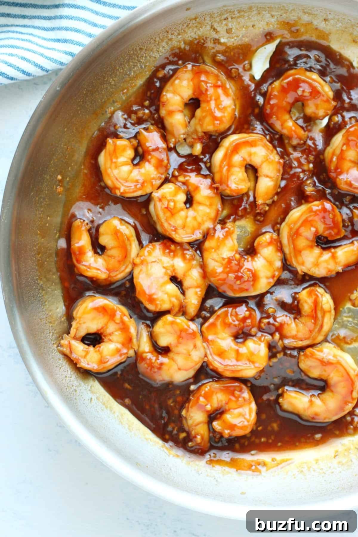 Shrimp with sauce in a pan, coated and ready to serve.