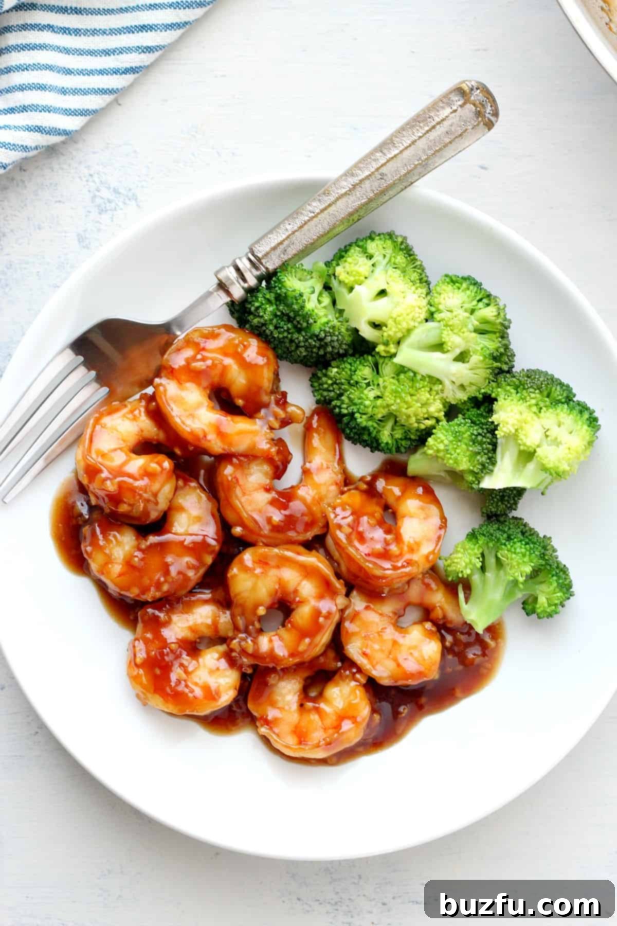 Shrimp and broccoli on a plate, ready to be enjoyed.