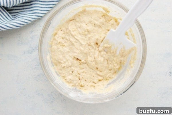 Thick hush puppy batter in a mixing bowl, ready for frying.