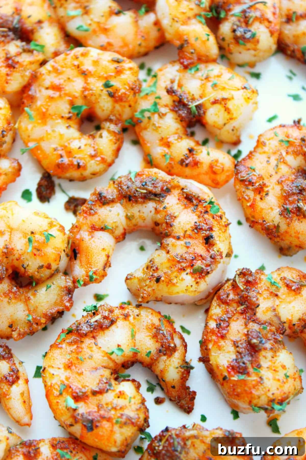 Air Fryer Shrimp Recipe Cooked shrimp on white plate.