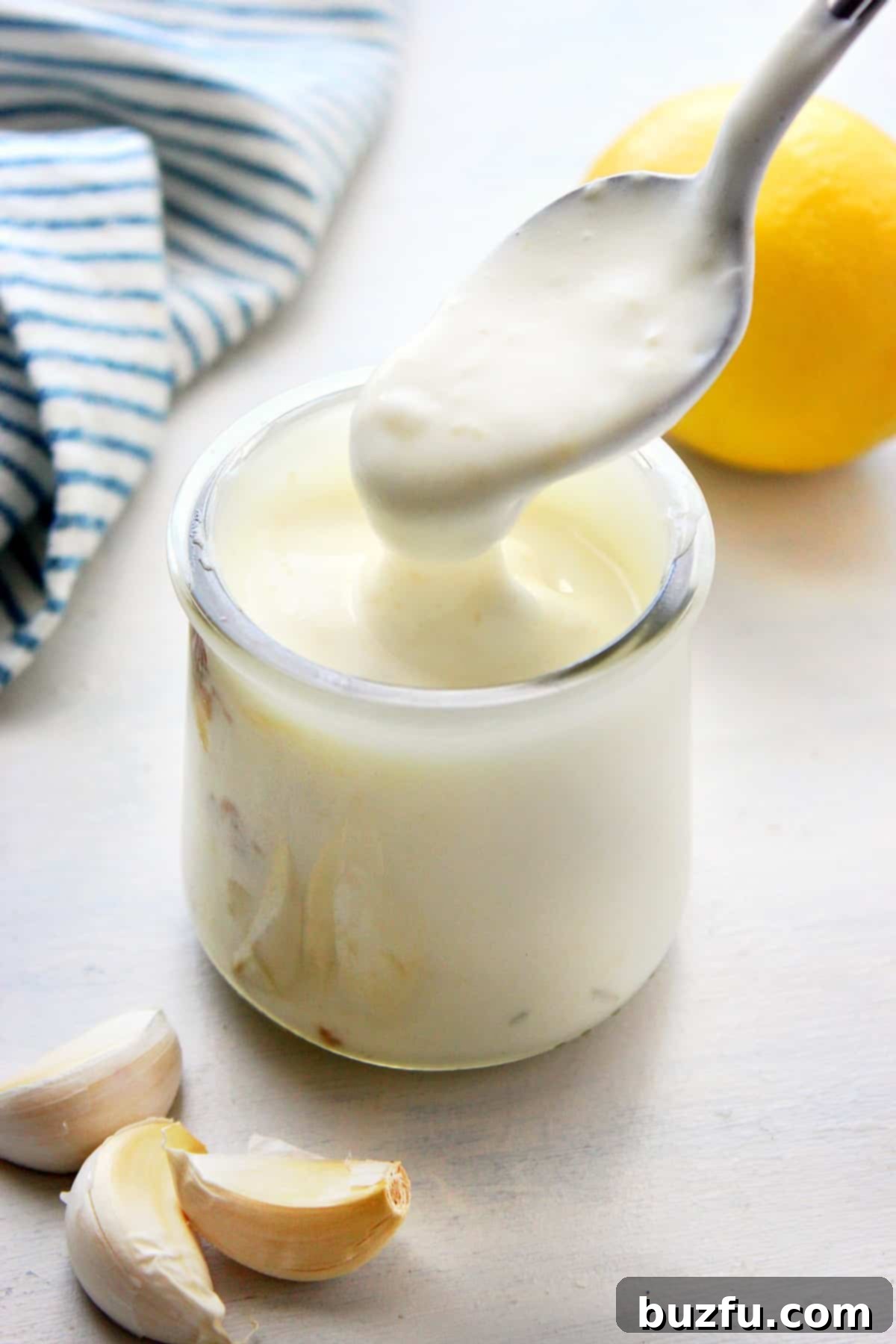 A small jar of creamy roasted garlic aioli, ready to be served as a dip or spread.