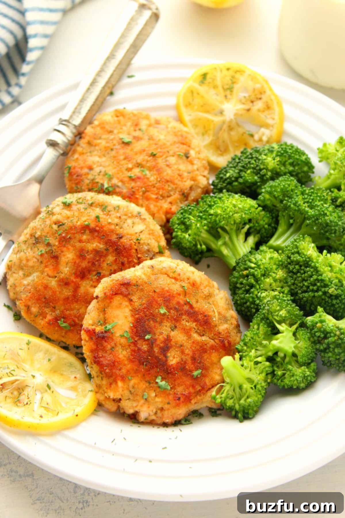Best Salmon Patties recipe: A simple and delicious seafood meal Crispy golden salmon cakes on a plate, garnished with fresh dill and lemon wedges.