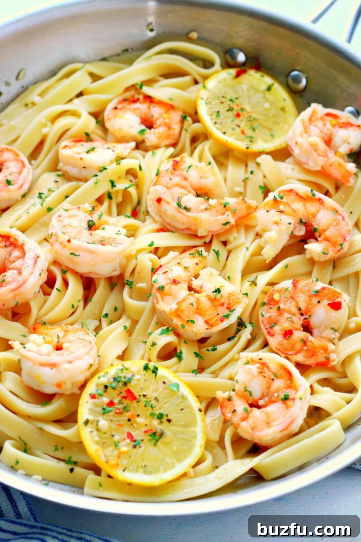 Shrimp with fettuccine in a pan.