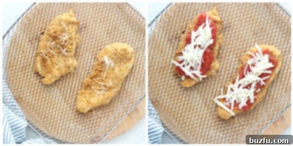 Air fried chicken cutlets topped with crushed tomatoes and mozzarella cheese, cooking in an air fryer basket.