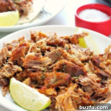 Effortless Crispy Instant Pot Carnitas 3 Carnitas meat on a white plate.