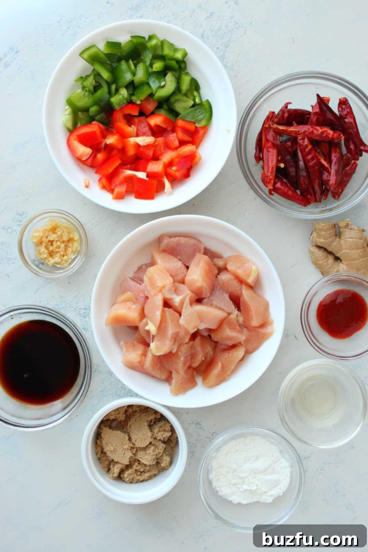 Kung Pao Chicken Ingredients List Array of fresh ingredients neatly arranged on a wooden board.