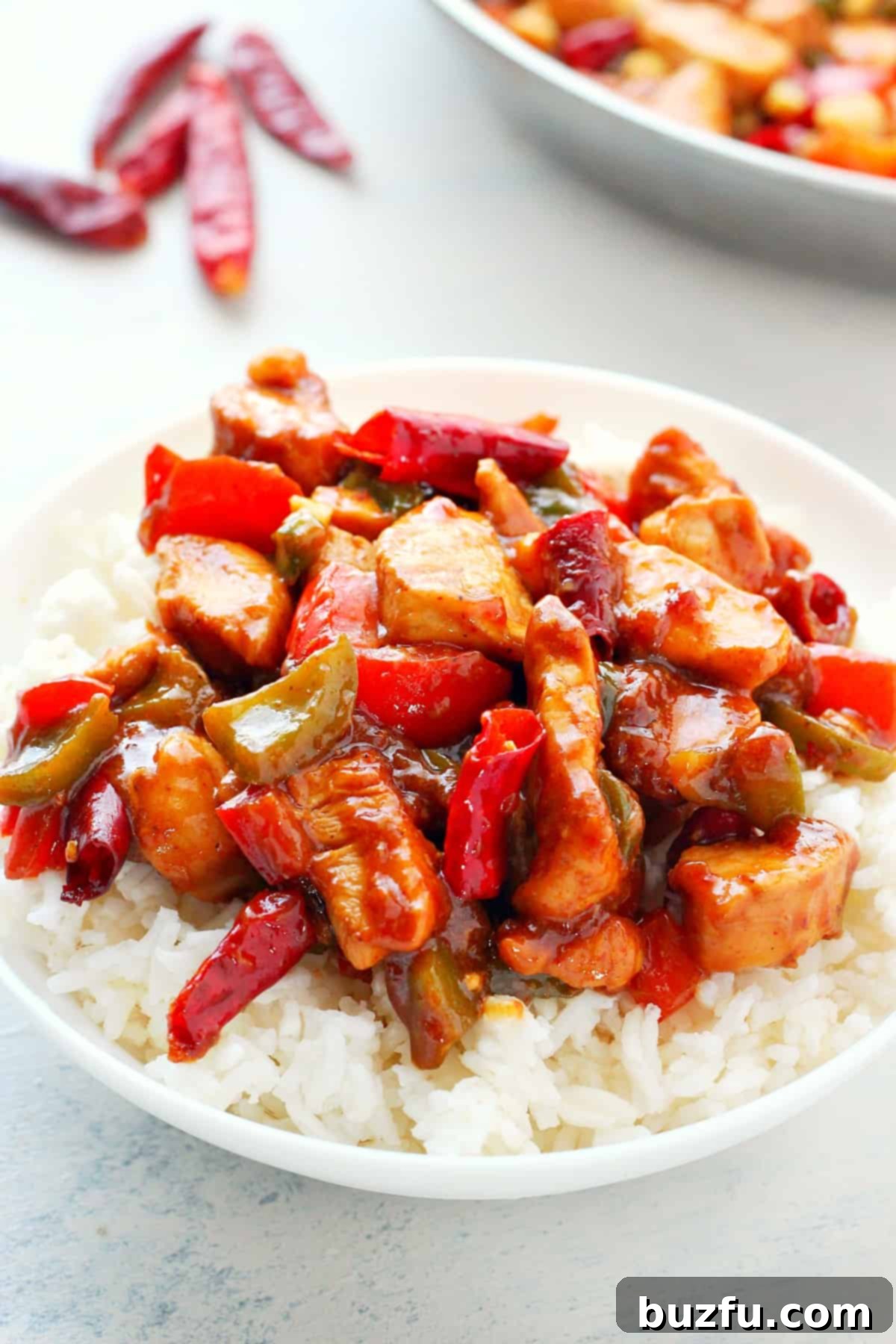Easy and Delicious Kung Pao Chicken Recipe Finished Kung Pao Chicken served on rice in a bowl, ready to eat.