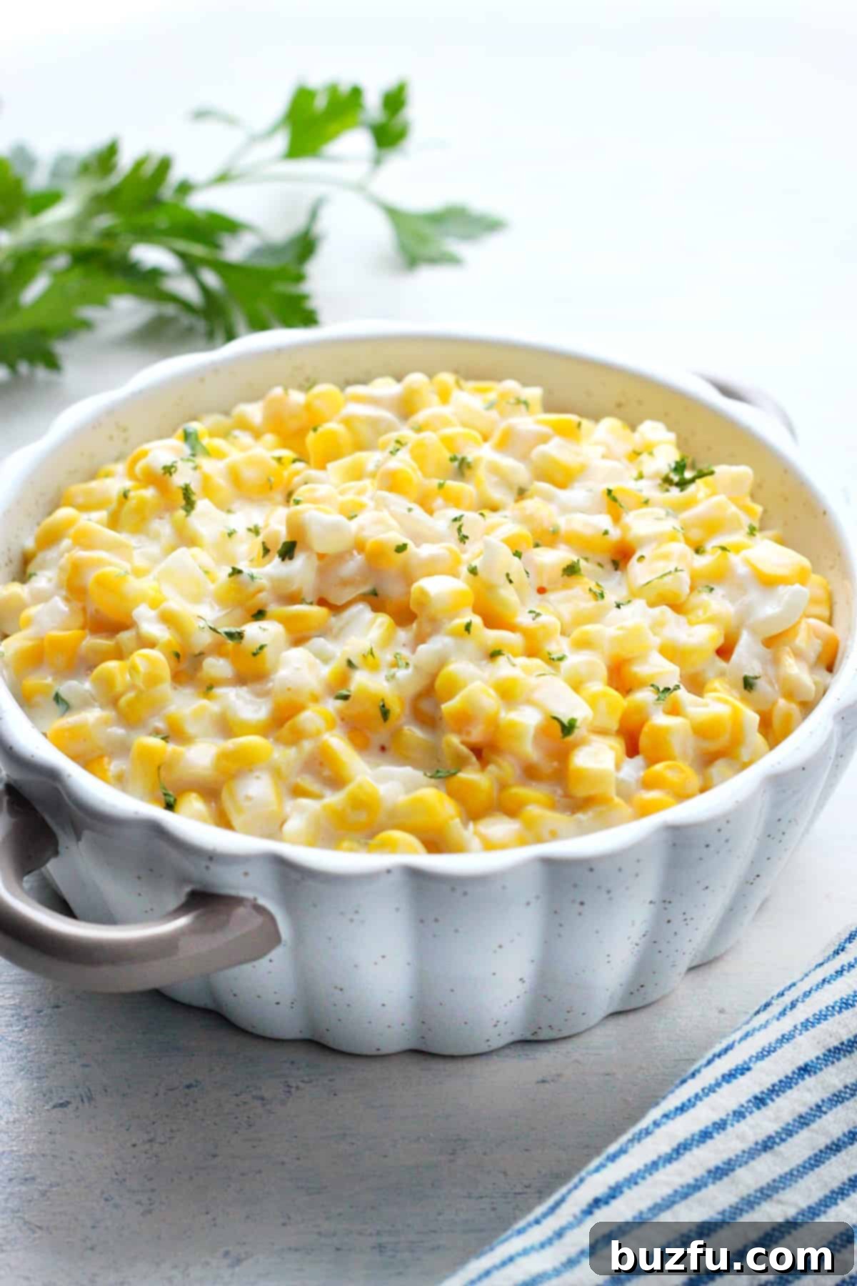 Corn in a creamy sauce in a serving dish, ready to be enjoyed.