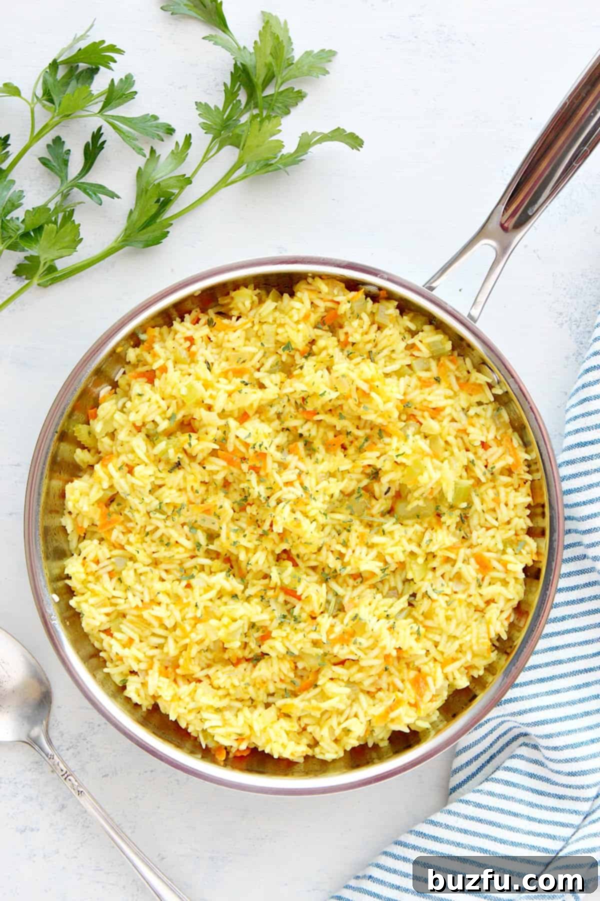 Homemade rice pilaf recipe. Freshly cooked rice pilaf served in a gleaming stainless steel pan, highlighting its delicious texture and inviting aroma.