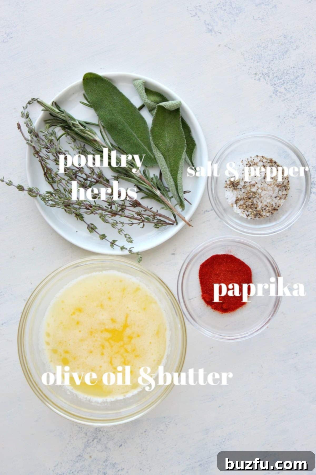Fresh ingredients for a roasted turkey, including herbs, spices, lemons, and vegetables, arranged on a wooden board.