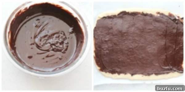 Rich chocolate filling evenly spread across the rolled-out yeast dough, ready for rolling.