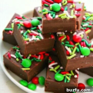 Irresistible Holiday Fudge 3 Rich, creamy chocolate fudge squares adorned with festive sprinkles on a white plate, ready for holiday enjoyment.