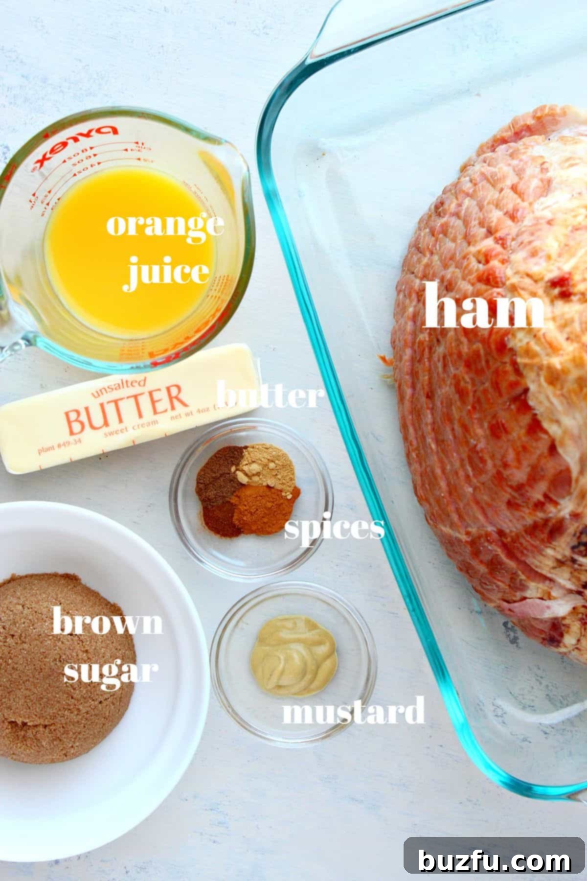 Christmas Ham ingredients for a flavorful glaze A collection of fresh ingredients laid out on a rustic wooden board, including a whole orange, spices, butter, and brown sugar, all essential for crafting the perfect Christmas ham glaze.