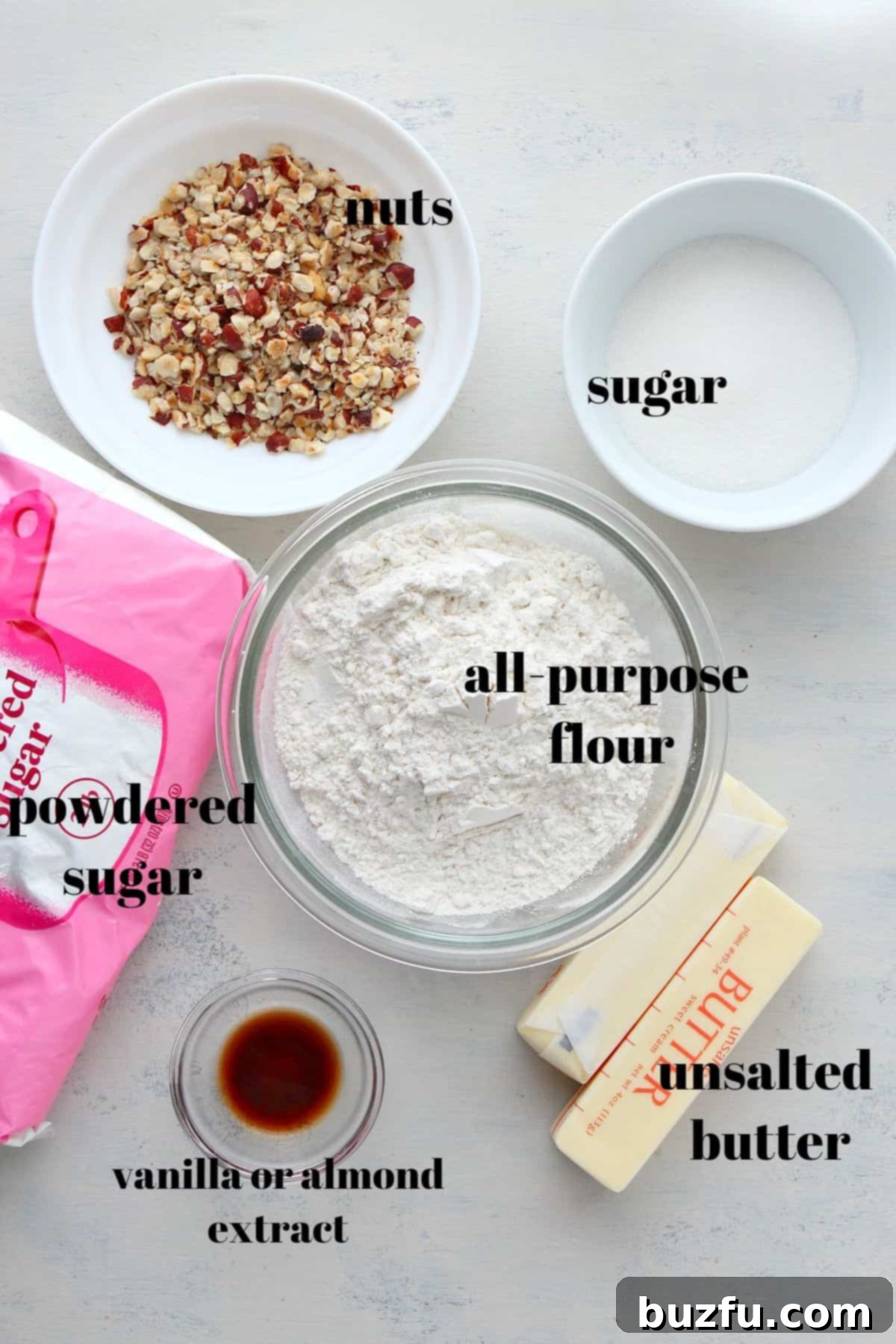 Key Ingredients for Classic Snowball Cookies Carefully arranged ingredients for making delicious snowball cookies, including flour, butter, sugar, vanilla, and chopped nuts.