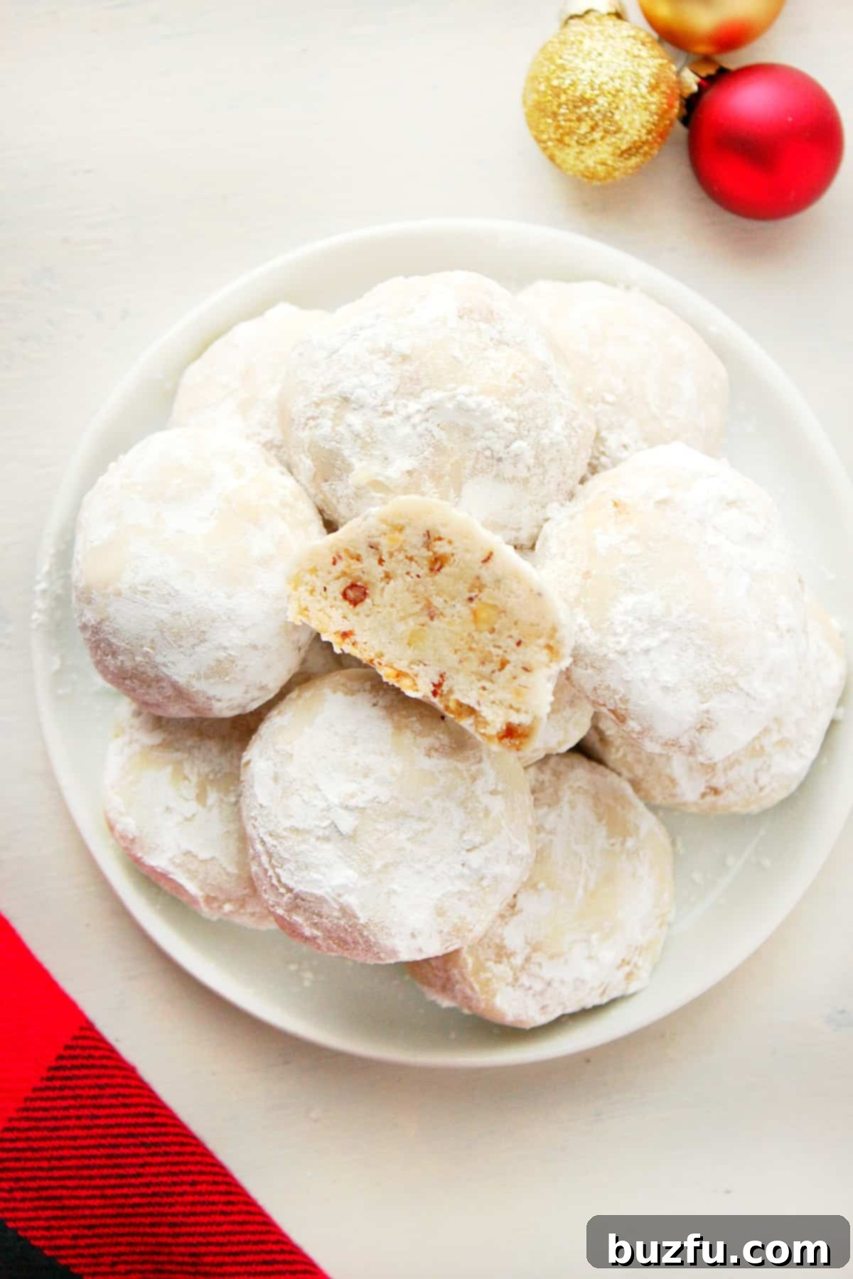 Beautifully Baked Classic Snowball Cookies A selection of Classic Snowball Cookies arranged appealingly on a decorative plate, highlighting their delicate powdered sugar coating.