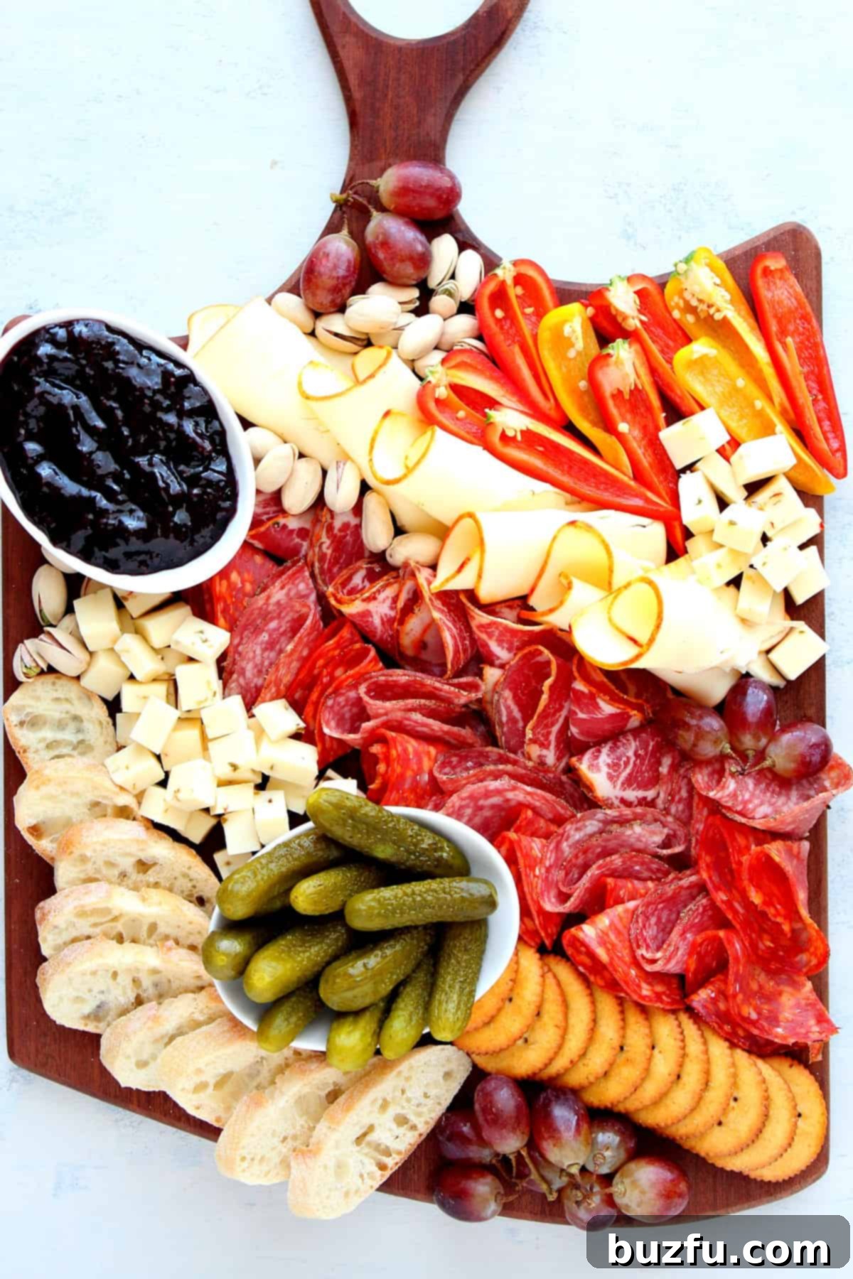 A vibrant Charcuterie Board featuring an array of cheeses, cured meats, and fresh vegetables, ready for serving.