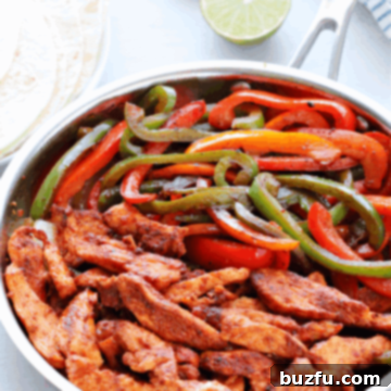 Effortless Sizzling Chicken Fajitas 3 Chicken fajitas in a stainless steel skillet, garnished with fresh cilantro and lime wedges.