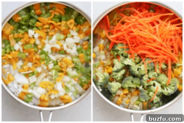 Chopped onion, peppers, broccoli, and carrots beginning to cook in a hot pan.