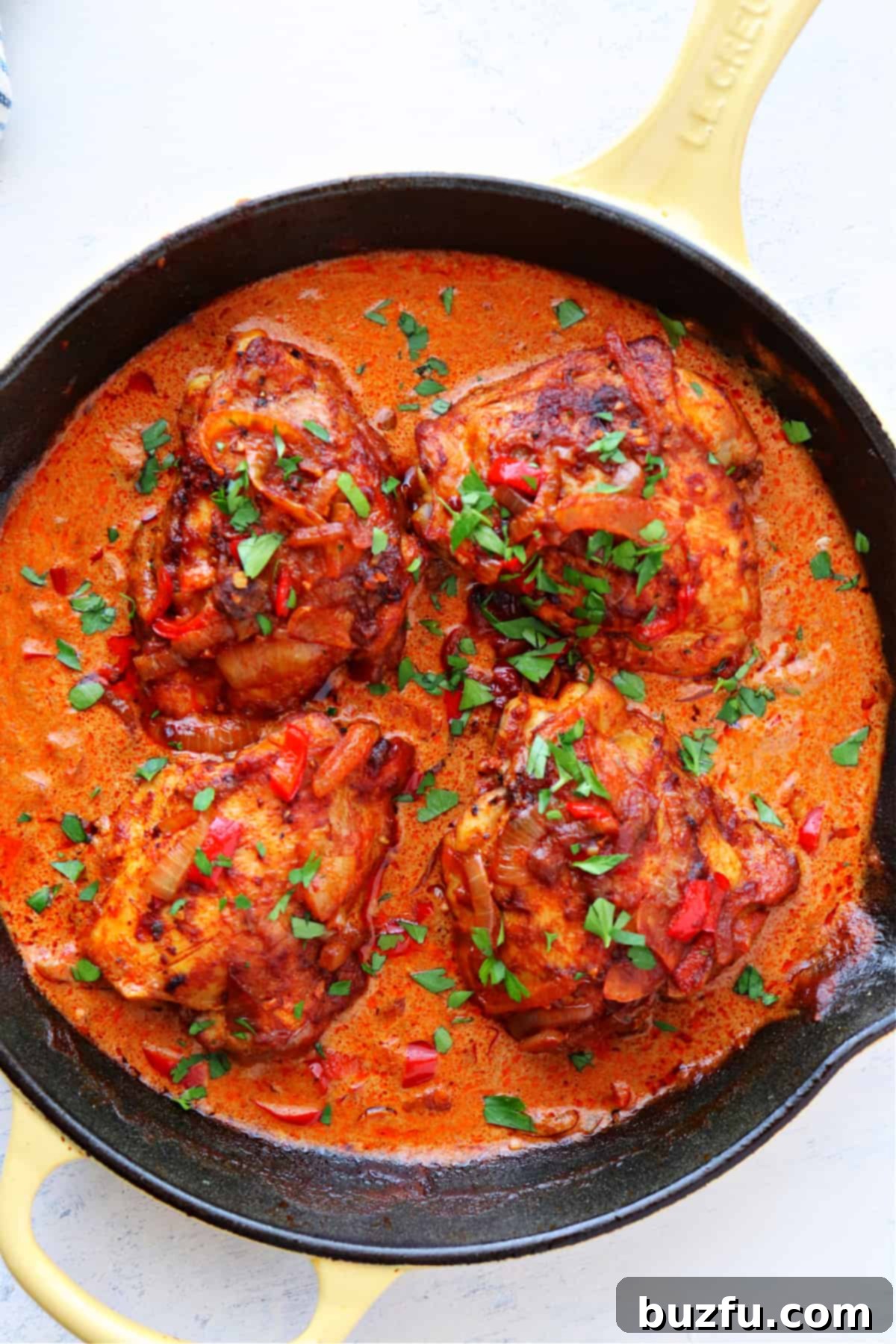Vibrant chicken paprikash in a large skillet, ready to be served, showcasing tender chicken in a rich paprika sauce.