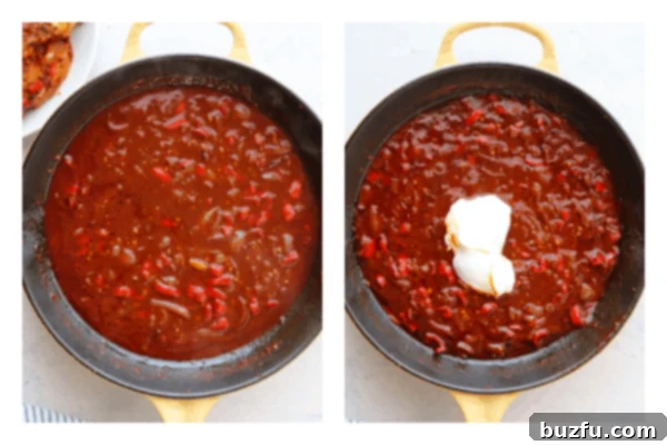 Close-up of the rich, thickened paprika sauce in a skillet, after sour cream has been stirred in, showing its creamy texture.