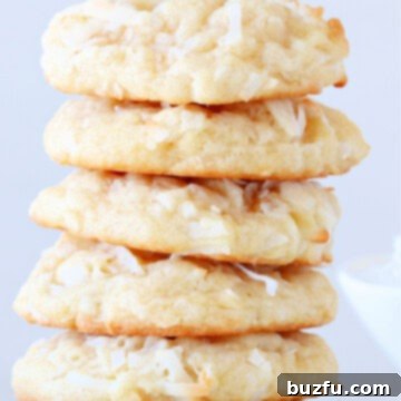 Tropical Coconut Bites 3 Close-up of freshly baked Coconut Cookies stacked on a plate.