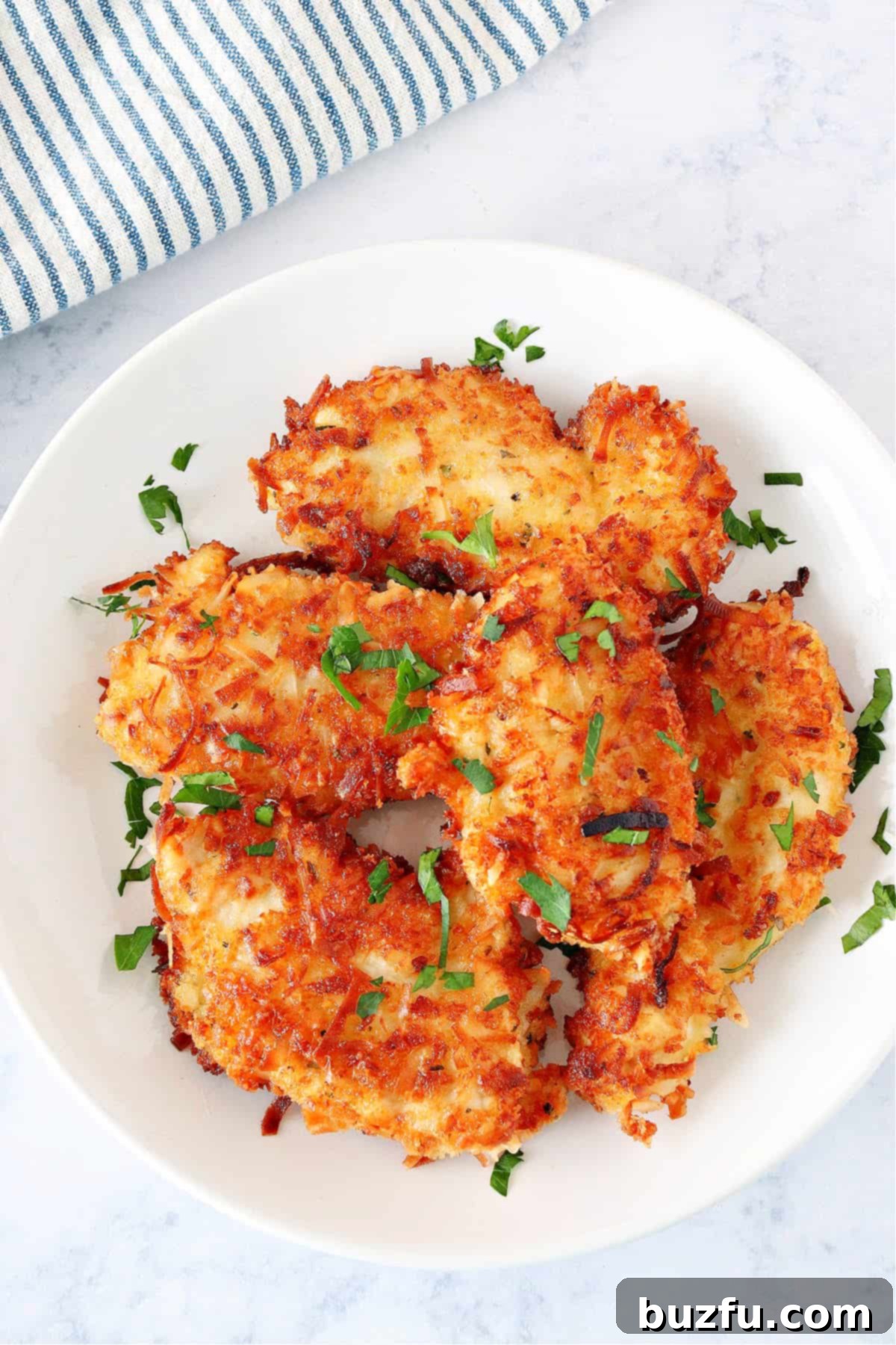 Delicious Crispy Coconut Chicken A perfectly cooked plate of crispy chicken with coconut, garnished and ready to be enjoyed, highlighting its golden exterior and delicious appeal.
