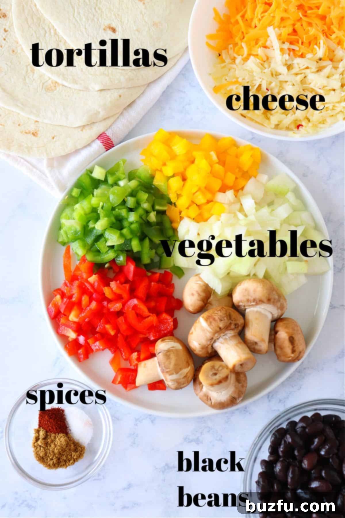 Ingredients for homemade vegetable quesadillas Fresh ingredients for vegetable quesadillas including bell peppers, onion, mushrooms, cheese, spices, and tortillas on a wooden cutting board.